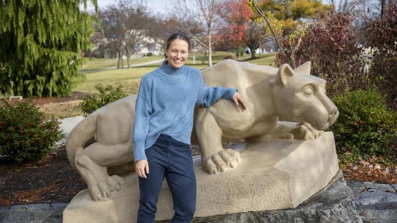 Diana Stoltzfus standing by the lion shrine