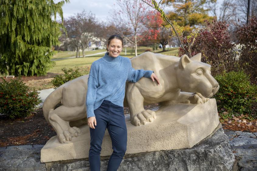 Diana Stoltzfus standing by the lion shrine